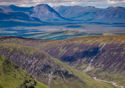 Lochan na h-achlaise on the vast peat bog moorland of rannoch moor, with glencoe in the distance.