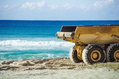 Cropped image of truck on shore at beach