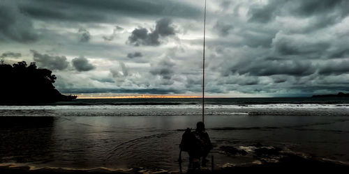 Scenic view of sea against storm clouds