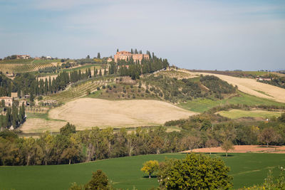 Scenic view of landscape and buildings against sky