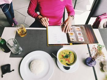 High angle view of woman having food in restaurant