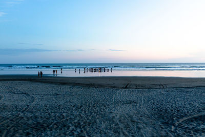 Scenic view of beach against sky during sunset