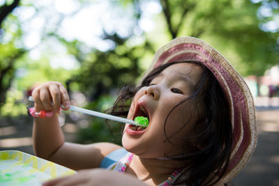 Close-up of girl eating ice cream on table