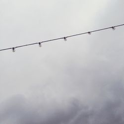 Low angle view of cables against sky