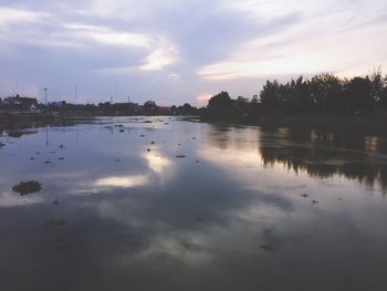 Scenic view of lake against cloudy sky