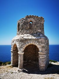 Old ruins of building against blue sky