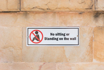 Close-up of warning sign on wall