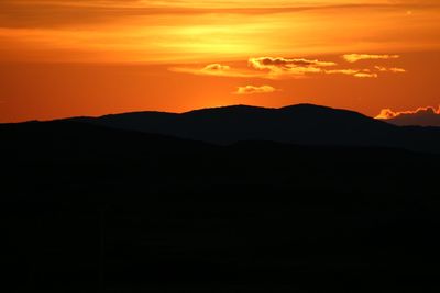 Silhouette of mountain against sky at sunset