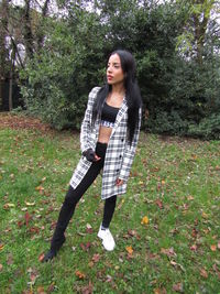 Portrait of beautiful young woman standing on land