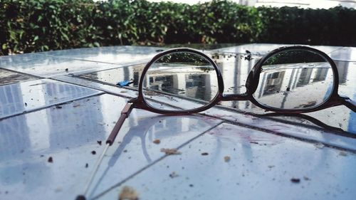 Close-up of sunglasses with reflection on mirror