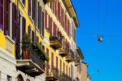 Low angle view of buildings against blue sky