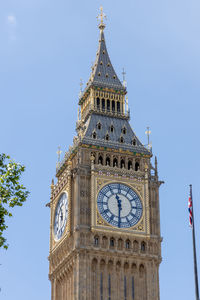 Low angle view of clock tower against clear sky