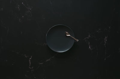 High angle view of coffee cup against black background