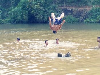 Men swimming in lake