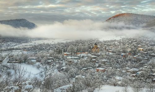 View of city against cloudy sky