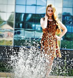 Portrait of young woman standing outdoors