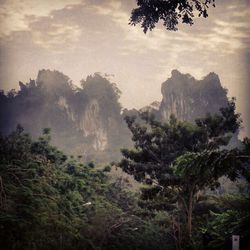 Scenic view of mountains against cloudy sky