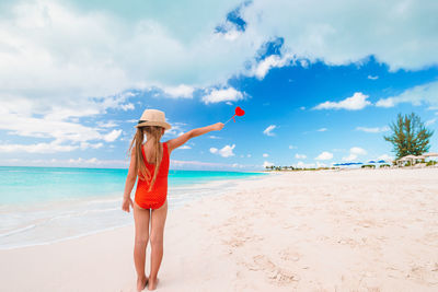 Full length of woman on beach against sky