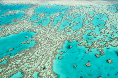 Full frame shot of blue sea water on sand