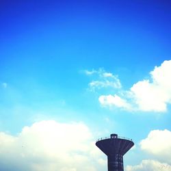Low angle view of water tower against blue sky