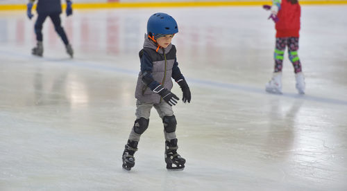 Boy ice skating on rink