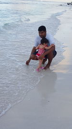 Portrait of father and daughter on beach