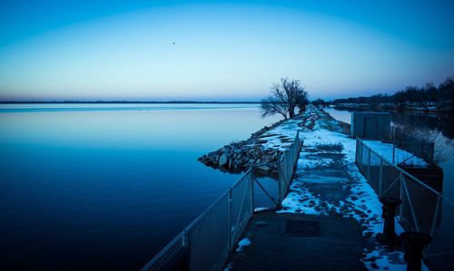 Scenic view of sea against clear sky during winter