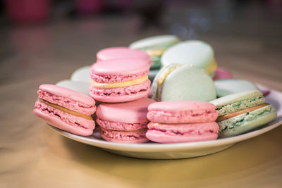 Close-up of pink and blue macaroons on table