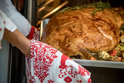 Close-up of hand holding food on table