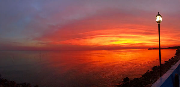 Scenic view of sea against orange sky