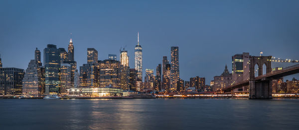 Illuminated buildings in city at waterfront