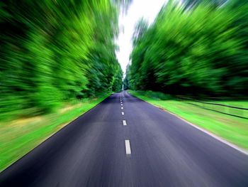 Road amidst trees against sky