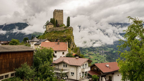 Buildings against cloudy sky