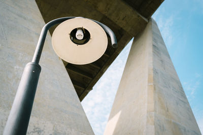 Low angle view of street light against bridge