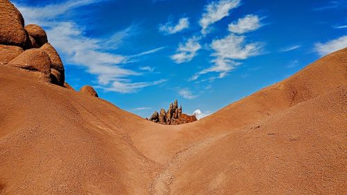 Panoramic view of arid landscape against sky