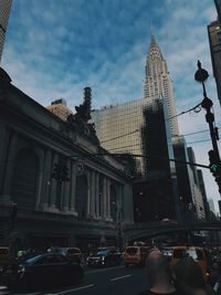 Low angle view of buildings against cloudy sky