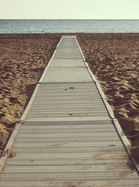 Pier over sea against clear sky