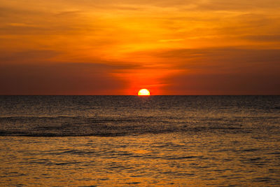 Scenic view of sea against orange sky