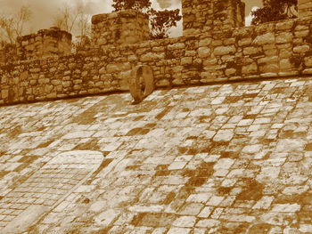 Low angle view of stone wall of old building