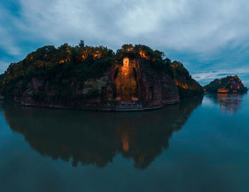 Scenic view of lake by building against sky