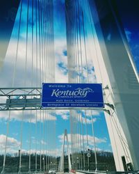 Close-up of suspension bridge against sky