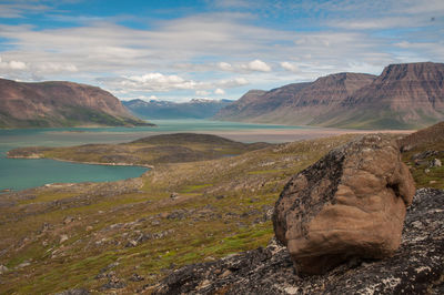 Scenic view of mountains against cloudy sky