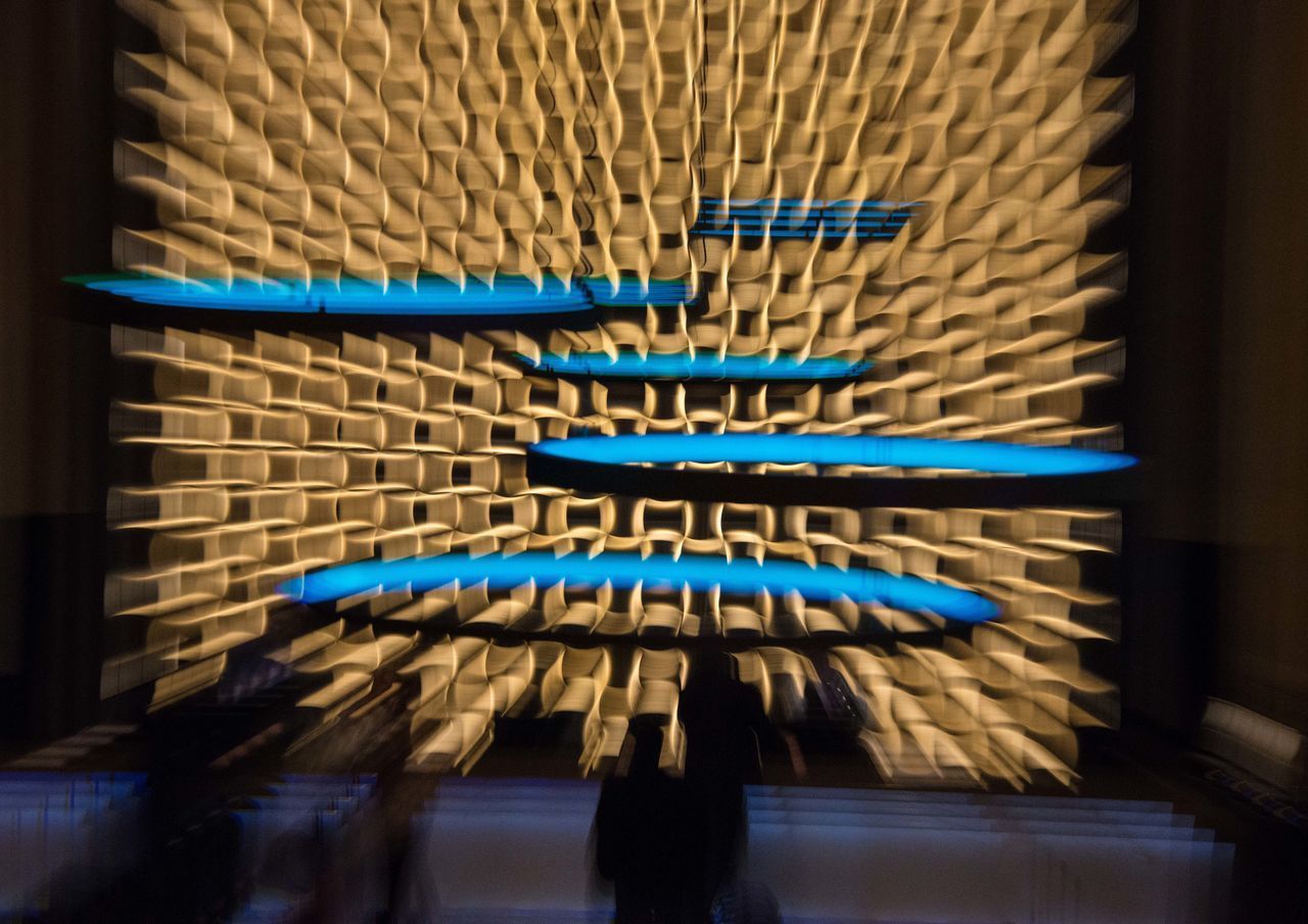 CLOSE-UP OF BLUE HANGING AGAINST WALL IN BUILDING