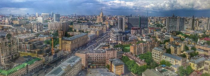 High angle view of cityscape against cloudy sky