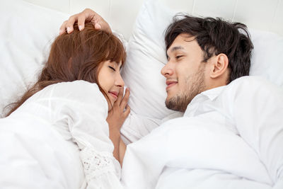 Young couple lying on bed