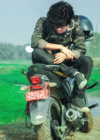 Man riding bicycle on field