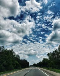 Road by trees against sky