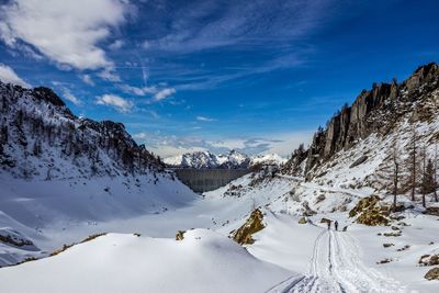 Scenic view of snow covered mountains against sky