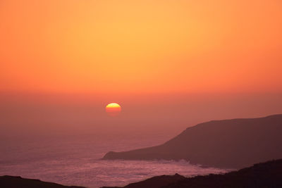 Scenic view of sea against romantic sky at sunset