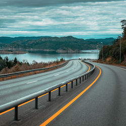 Road by mountain against sky